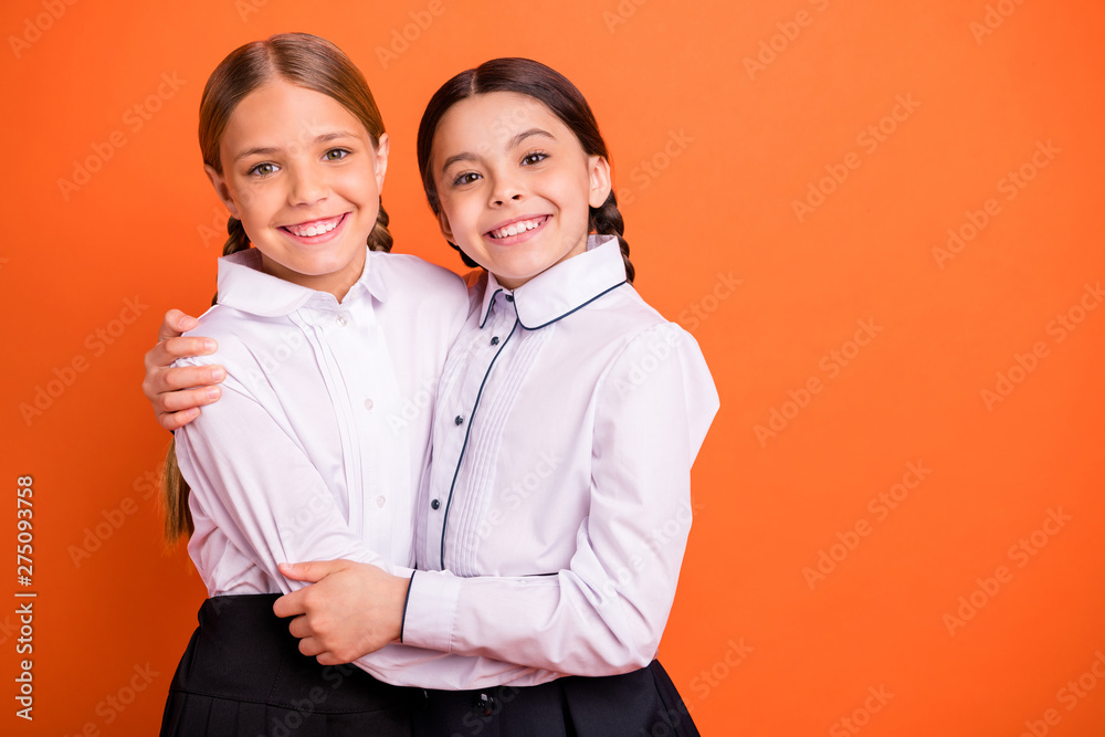 Portrait of two person nice-looking attractive charming cute sweet lovely tender cheerful cheery glad pre-teen girls isolated over bright vivid shine orange background Portrait of two person nice-looking attractive charming cute sweet lovely tender cheerful cheery glad pre-teen girls isolated over bright vivid shine orange background