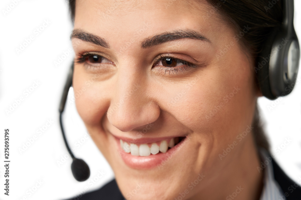 Close Up Of Businesswoman Wearing Telephone Headset In Customer Services Department Close Up Of Businesswoman Wearing Telephone Headset In Customer Services Department
