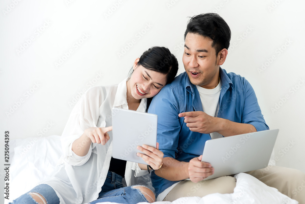 Surprising Asian couple using laptop at home, lifestyle concept. Surprising Asian couple using laptop at home, lifestyle concept.