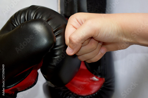 young hand against a boxing glove