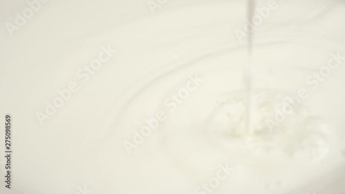 Pouring Milk closeup. Milk Splesh Slow Motion. photo