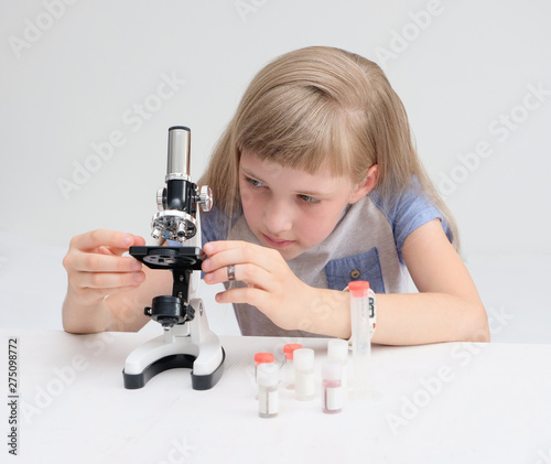 The student conducts an experiment with a microscope photo