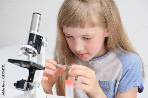 The student conducts an experiment with a microscope photo
