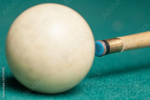 Billiard balls and a stick on a green table. Billiard balls isolated on a green background