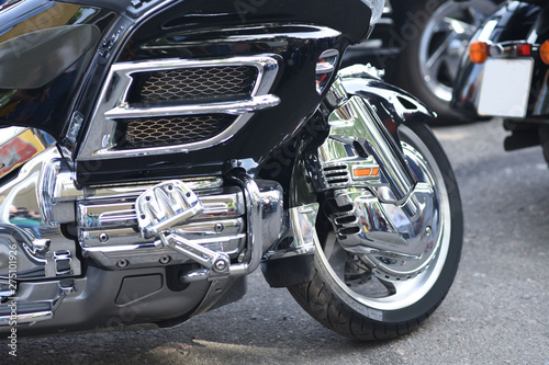 A motorbike on the show with chrome details and other parts  closeup with depth of field openair