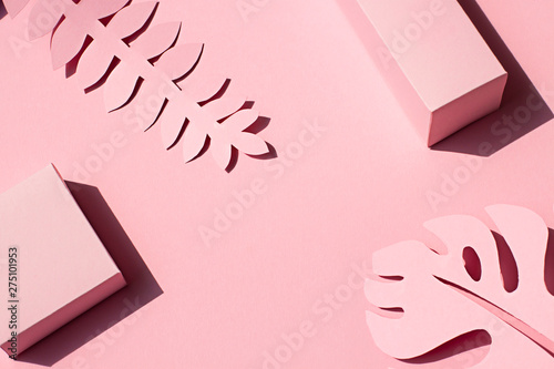 Paper tropical plants leaves on the pink background. Summer concept Top view