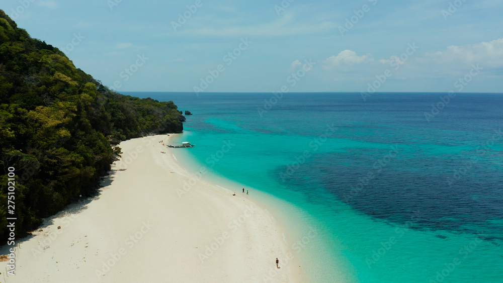 Tropical landscape: Sandy beach with palm trees and turquoise waters of the coral reef top view, Puka shell beach. Boracay, Philippines. Seascape with beach on tropical island. Summer and travel