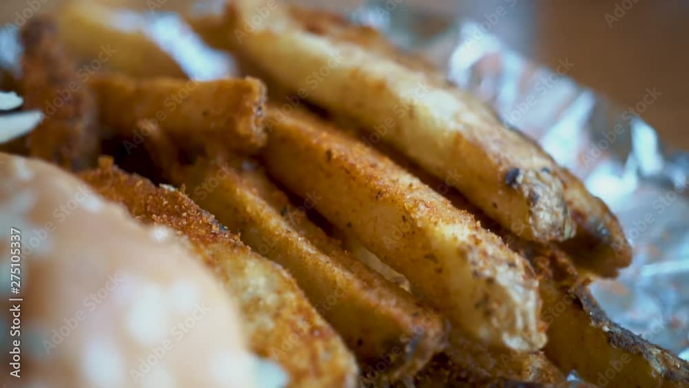Macro Close Up of steak fries and double cheeseburger with sesame bun