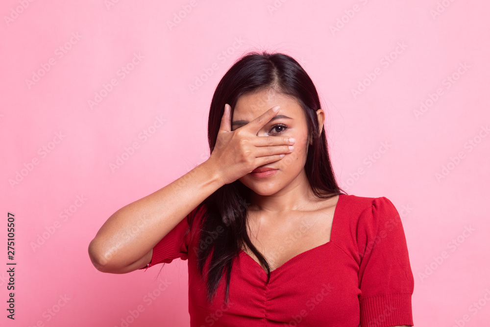 Beautiful young Asian woman peeking through fingers. Beautiful young Asian woman peeking through fingers.