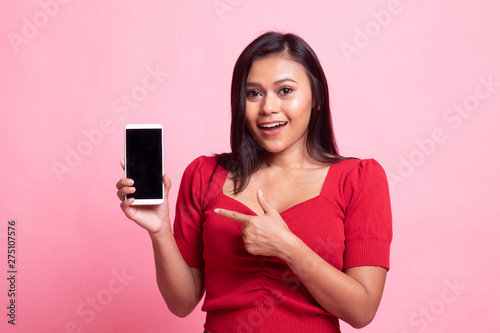 Excited Young Asian woman point to mobile phone.