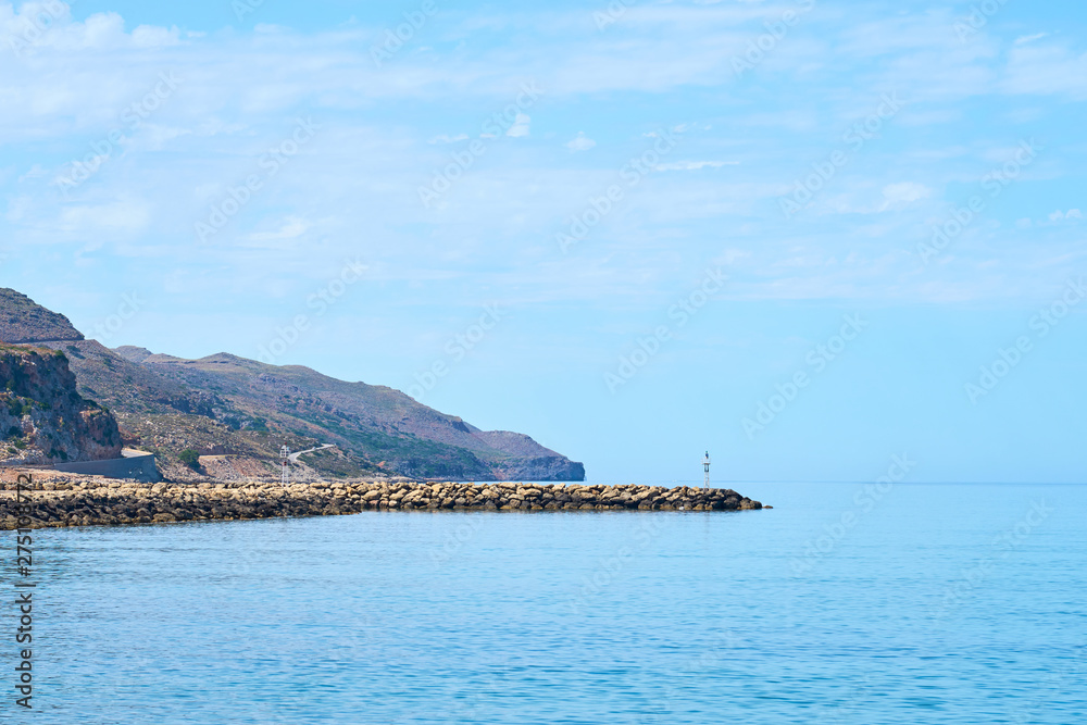 Seaside and harbor in Colimbari, Crete, Greece with blue sky and sea. Copy space. 