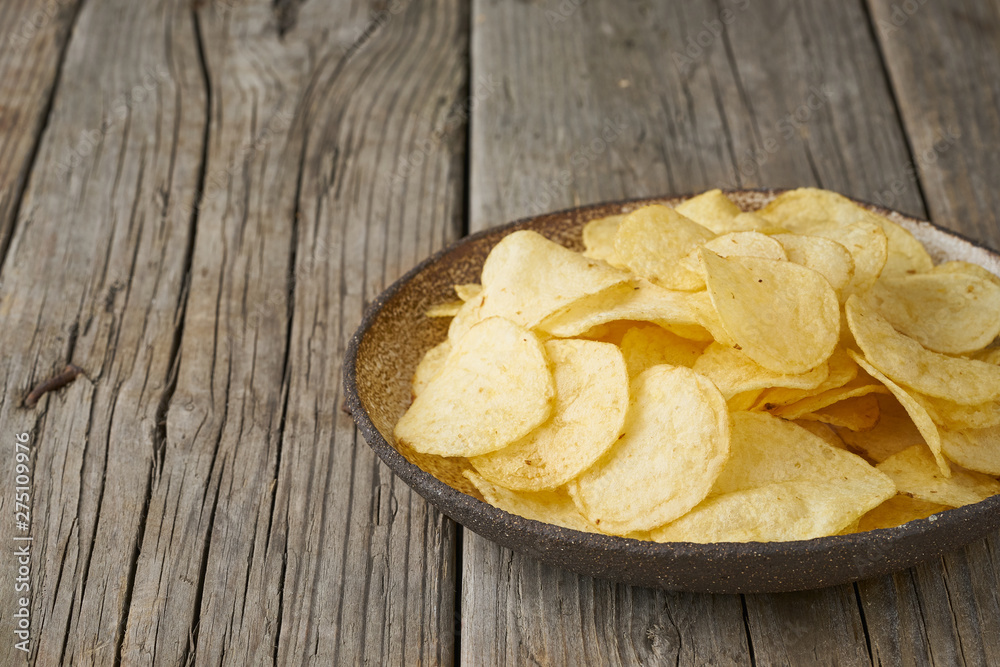 crisp in bowl, wooden background, closeup, copy space crisp in bowl, wooden background, closeup, copy space