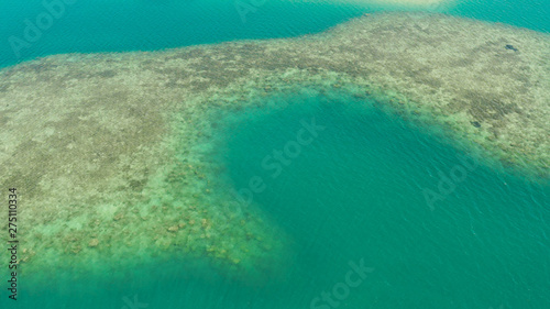 Sea water surface in lagoon and coral reef, copy space for text, aerial view Top view transparent turquoise ocean water surface. background texture © Alex Traveler