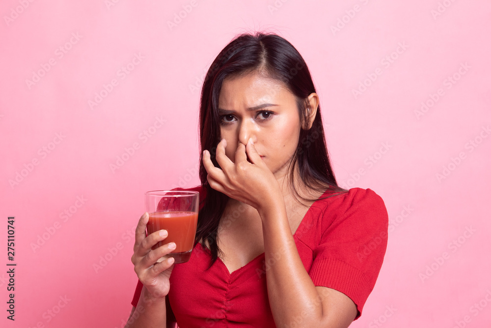 Young Asian woman hate tomato juice. Young Asian woman hate tomato juice.