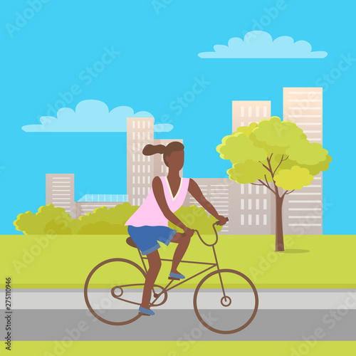 Afro-american woman riding on bike in city park with trees, bushes and buildings. Vector teenage girl at bicycle, cartoon character female ride on cycle