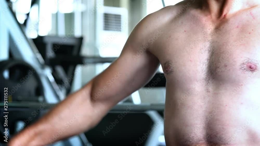 4K Medium shot of men lifts dumbbells to strengthen his biceps muscles for strong bodybuilding. Men pumping up his biceps muscles by weight training workout in fitness gym sport club. 4K Medium shot of men lifts dumbbells to strengthen his biceps muscles for strong bodybuilding. Men pumping up his biceps muscles by weight training workout in fitness gym sport club.