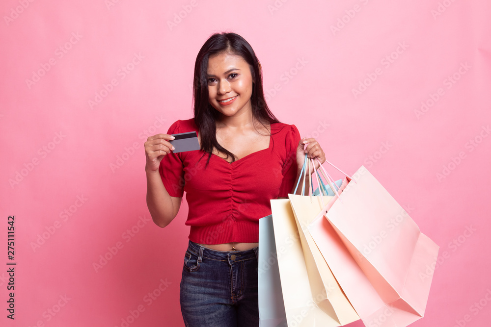 Young Asian woman with shopping bag and blank card. Young Asian woman with shopping bag and blank card.
