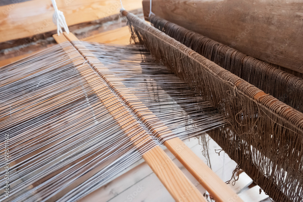 Old loom. Cotton is raw for weave tools to work natural textile fiber. Close-up.
