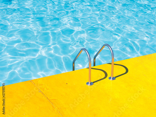 Grab bars ladder in the blue swimming pool. 3d render photo