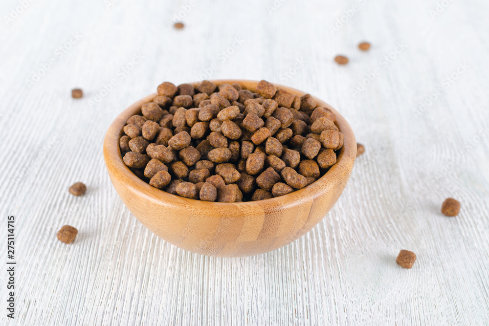 dog food in a wooden bowl on the table dog food in a wooden bowl on the table