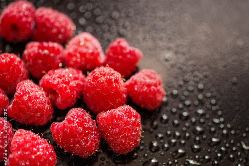 Wet fresh raspberry on black glossy background. Wet fresh raspberry on black glossy background.