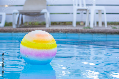 empty swimming pool on a back yard cottage place with ball on a smooth water surface, rest concept photography wallpaper with empty copy space for text