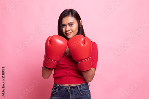 Young Asian woman with red boxing gloves.