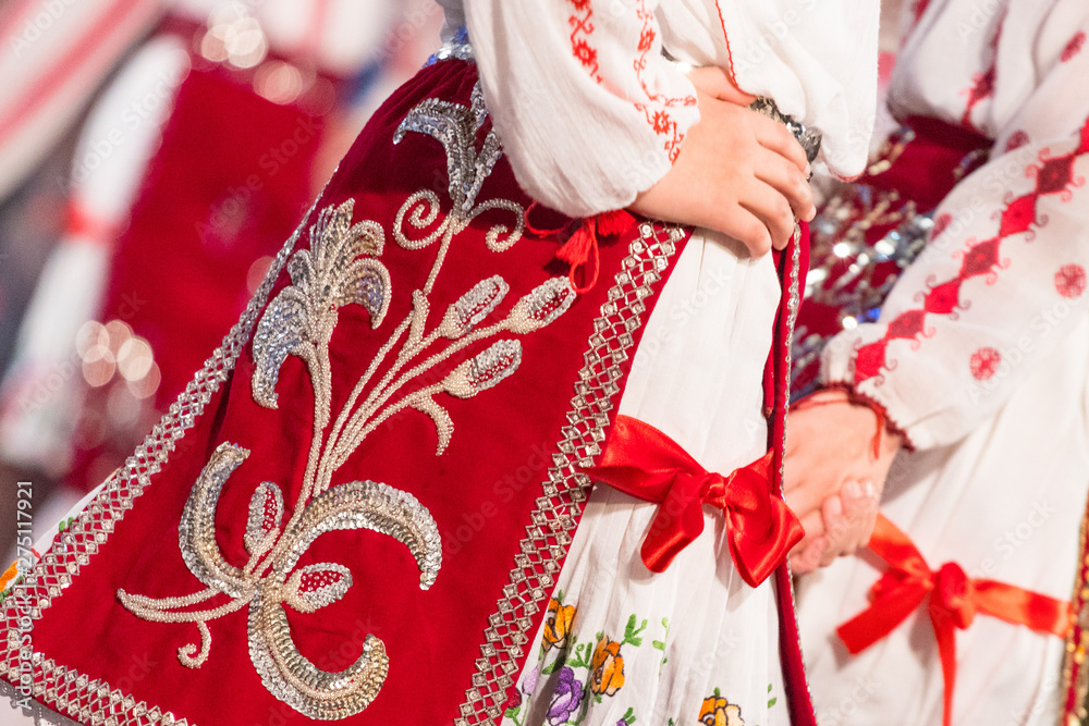 Close up of young Romanian dancers perform a folk dance in traditional folkloric costume. Folklore of Romania
