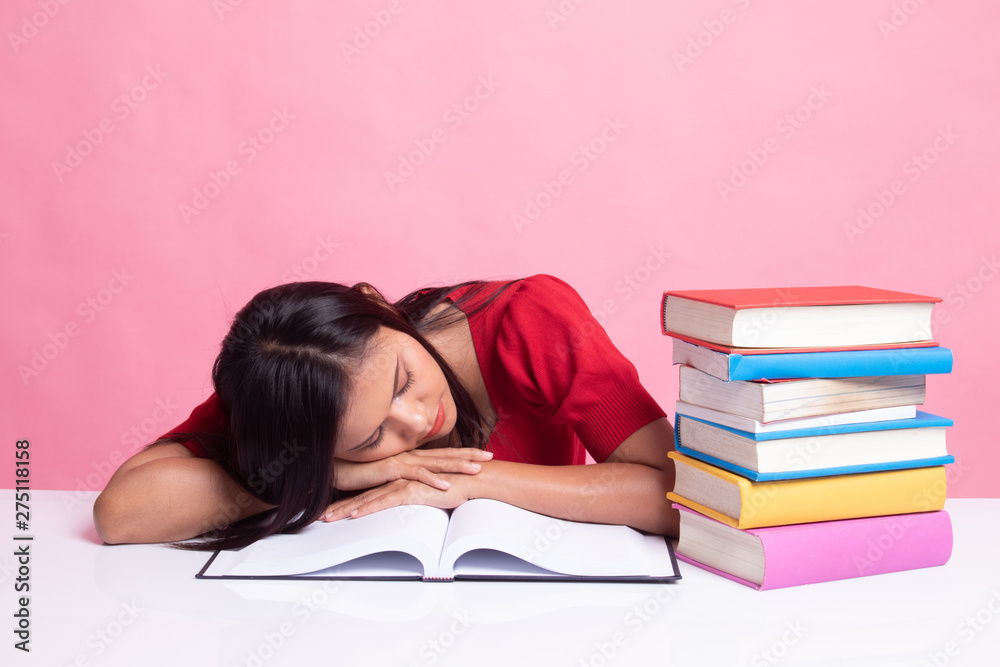 Exhausted Young Asian woman sleep with books on table. Exhausted Young Asian woman sleep with books on table.