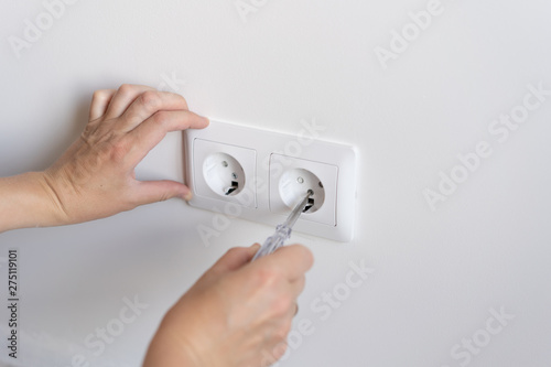 non-female work. repair and decoration. woman repairs outlets in a new apartment