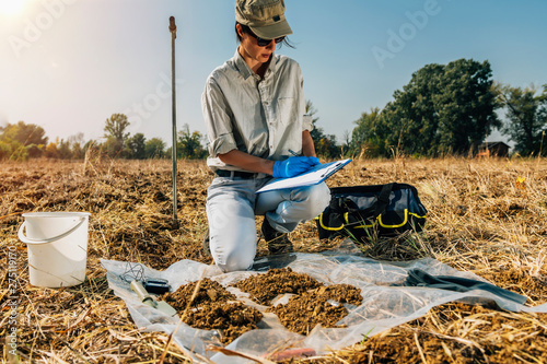Soil Test. Female Agronomist Taking Notes In The Field