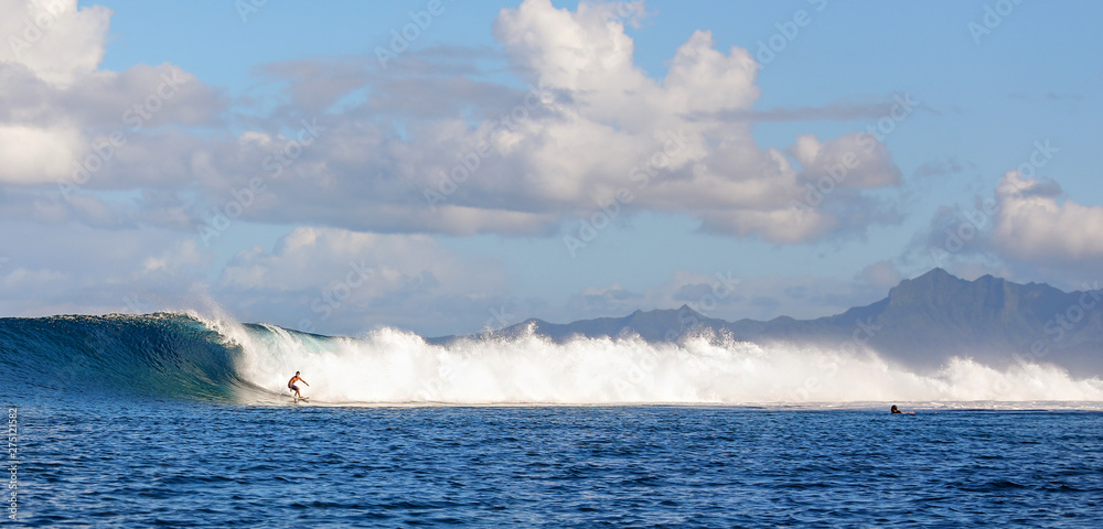 surfer catching the break in tahiti, bora bora. 