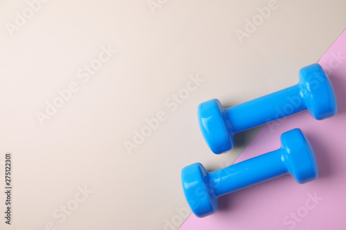 Vinyl dumbbells and space for text on color background, flat lay
