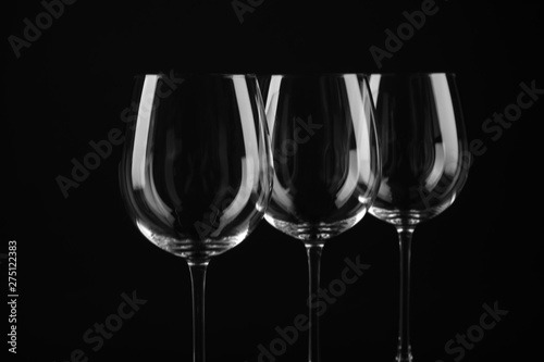 Set of empty wine glasses on black background