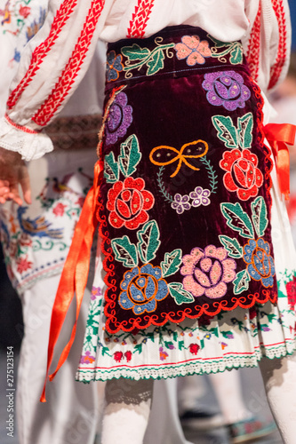 Detail of traditional folkloric costume of Romanian dancers perform a folk dance. Folklore of Romania