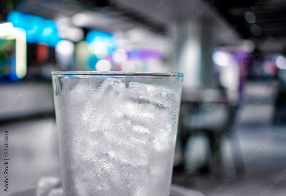 Chilled Glass Filled with Tubular Shaped Ice in a Bar.