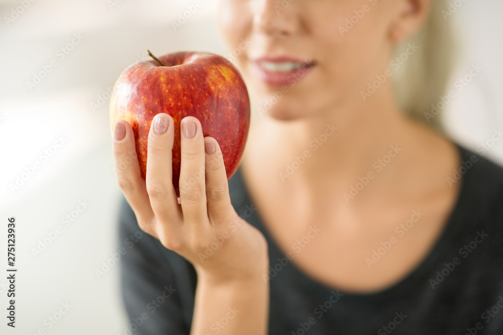 food, diet and people concept - close up of woman holding ripe red apple food, diet and people concept - close up of woman holding ripe red apple