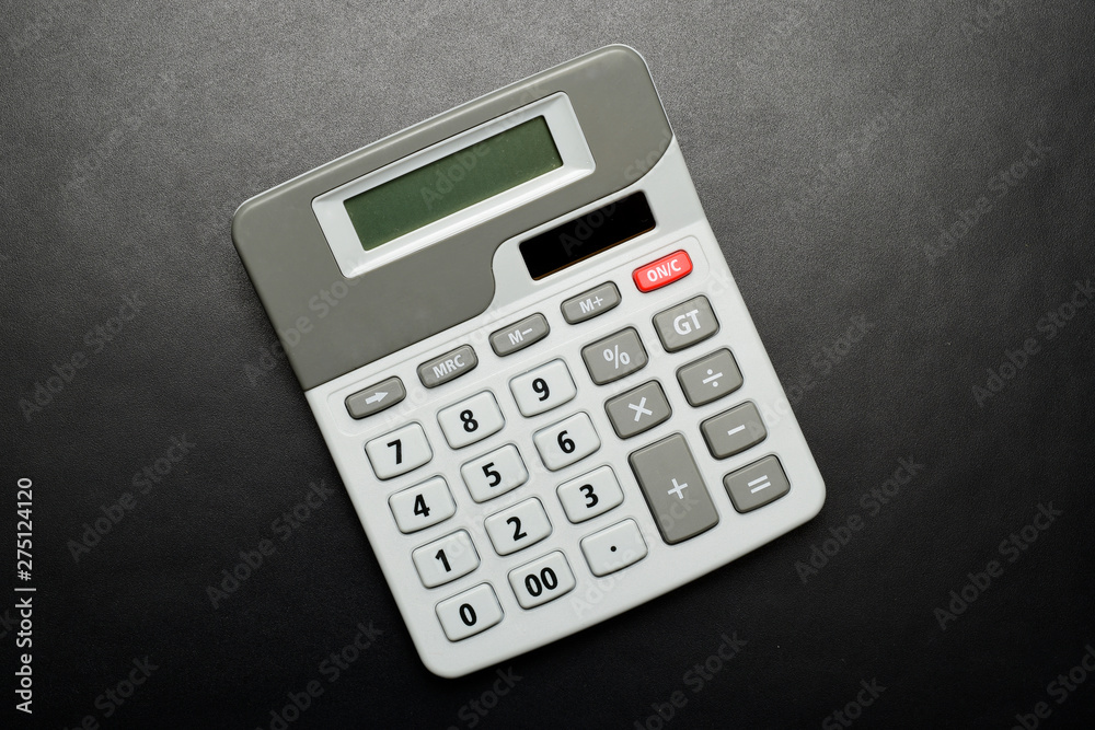 calculator on black texture background, top view. calculator on black texture background, top view.