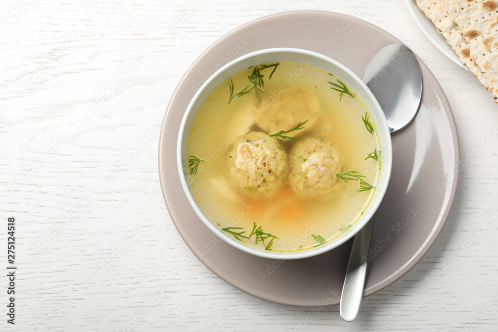 Flat lay composition with Jewish matzoh balls soup on white wooden table. Space for text Flat lay composition with Jewish matzoh balls soup on white wooden table. Space for text