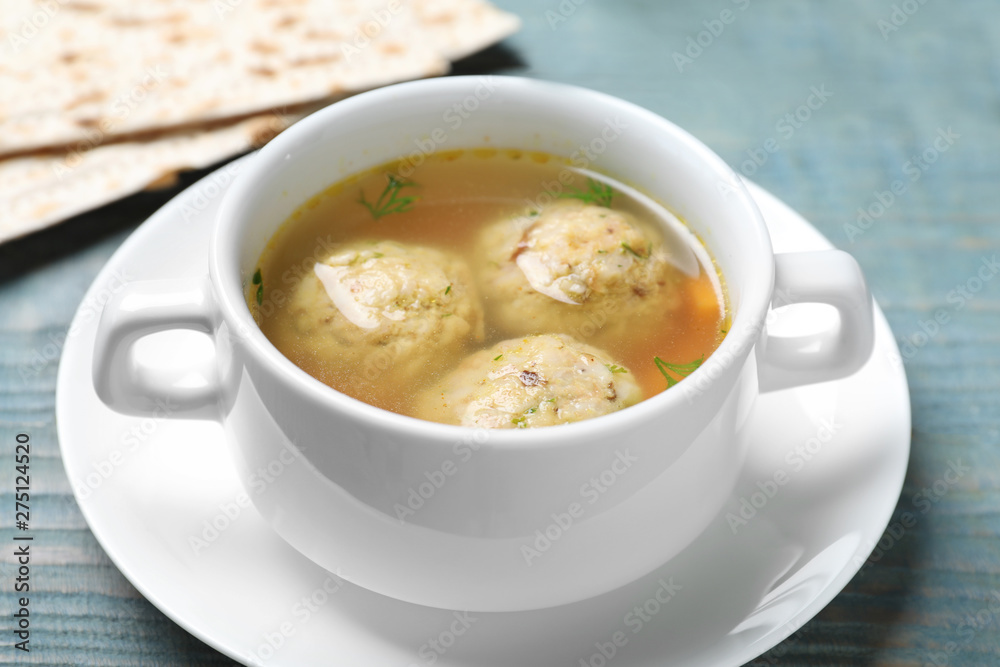 Bowl of Jewish matzoh balls soup on color wooden table Bowl of Jewish matzoh balls soup on color wooden table