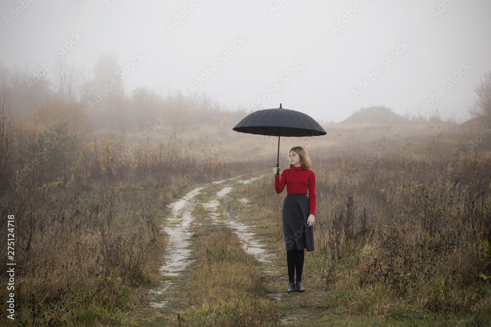 young girl with umbrella in autumn field young girl with umbrella in autumn field