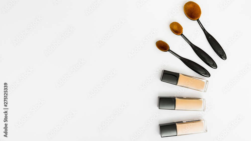 Set of oval makeup brushes with liquid foundation bottles on white backdrop  Stock Photo | Adobe Stock