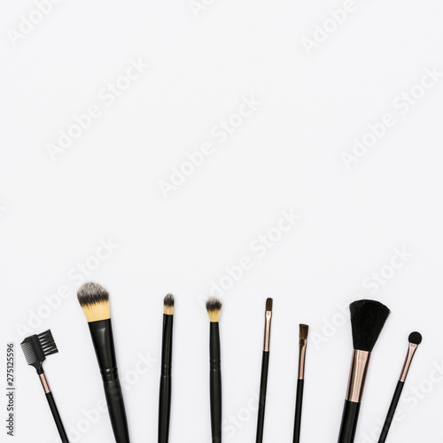 Row of makeup brushes with copy space for writing the text on white background