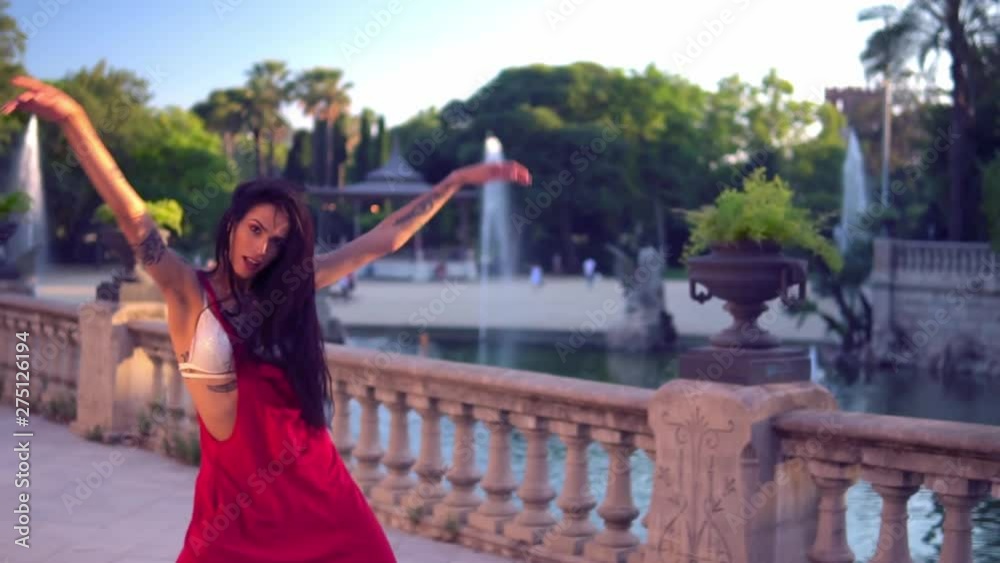 tattooed transgender model is dancing in the green park. Emotional dance movements