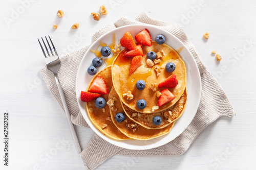 pancakes with blueberry strawberry honey and nuts for breakfast photo
