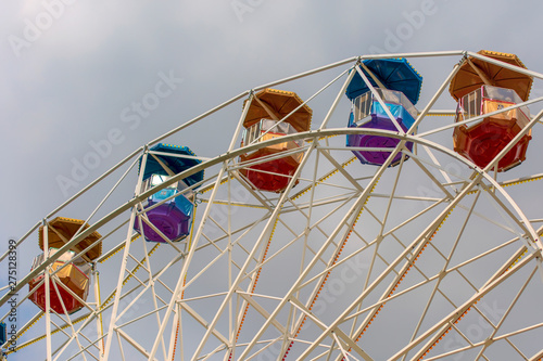 Ferris wheel in the amusement Park with storm gray clouds in the sky.