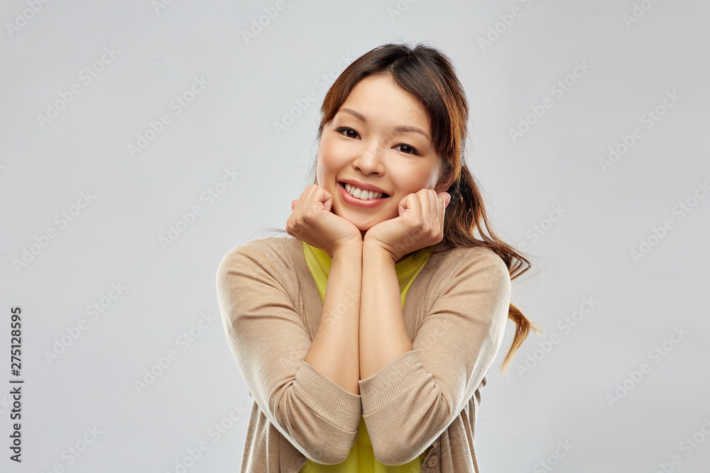 people, ethnicity and portrait concept - cute asian young woman over grey background people, ethnicity and portrait concept - cute asian young woman over grey background