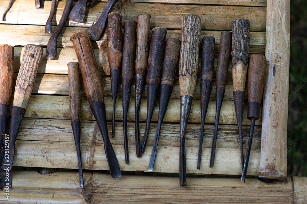 Closeup enormously of wood carving for skillfull wooden timber carpenter craft art work on old background.