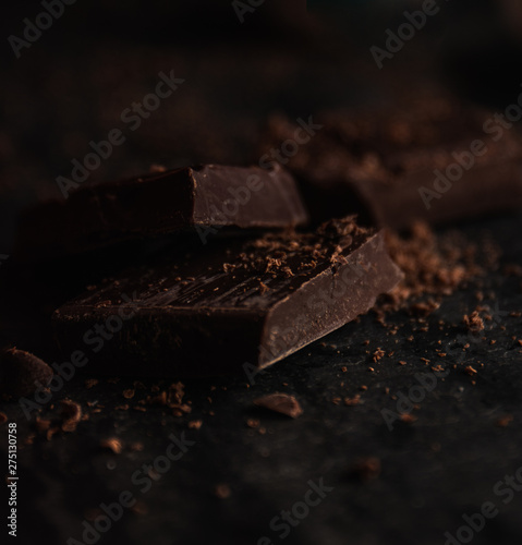 Delicious dark bitter chocolate over a black background