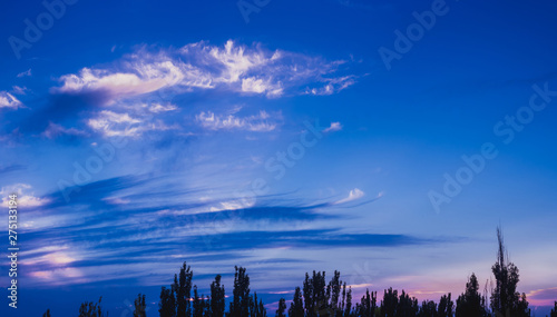 Landscape with dramatic light - beautiful golden sunset with saturated sky and clouds.